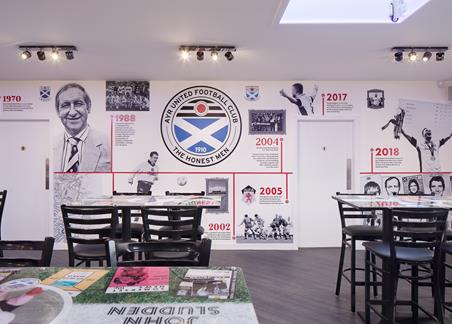 Photograph showing the interior of the social area at Somerset Hub, including wall decals.