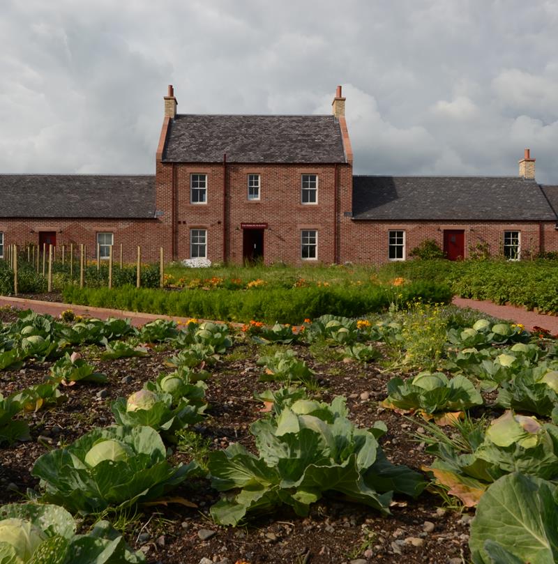 A photograph showing an exterior view of the Pierburg Education Centre in Dumfries, with the cabbage patch in the foreground.