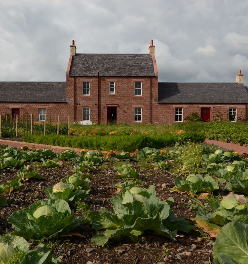 A photograph showing an exterior view of the Pierburg Education Centre in Dumfries, with the cabbage patch in the foreground.