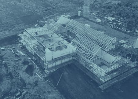 Photograph showing the build in progress at the site of The Courtyard private residential project, in turquoise duotone.